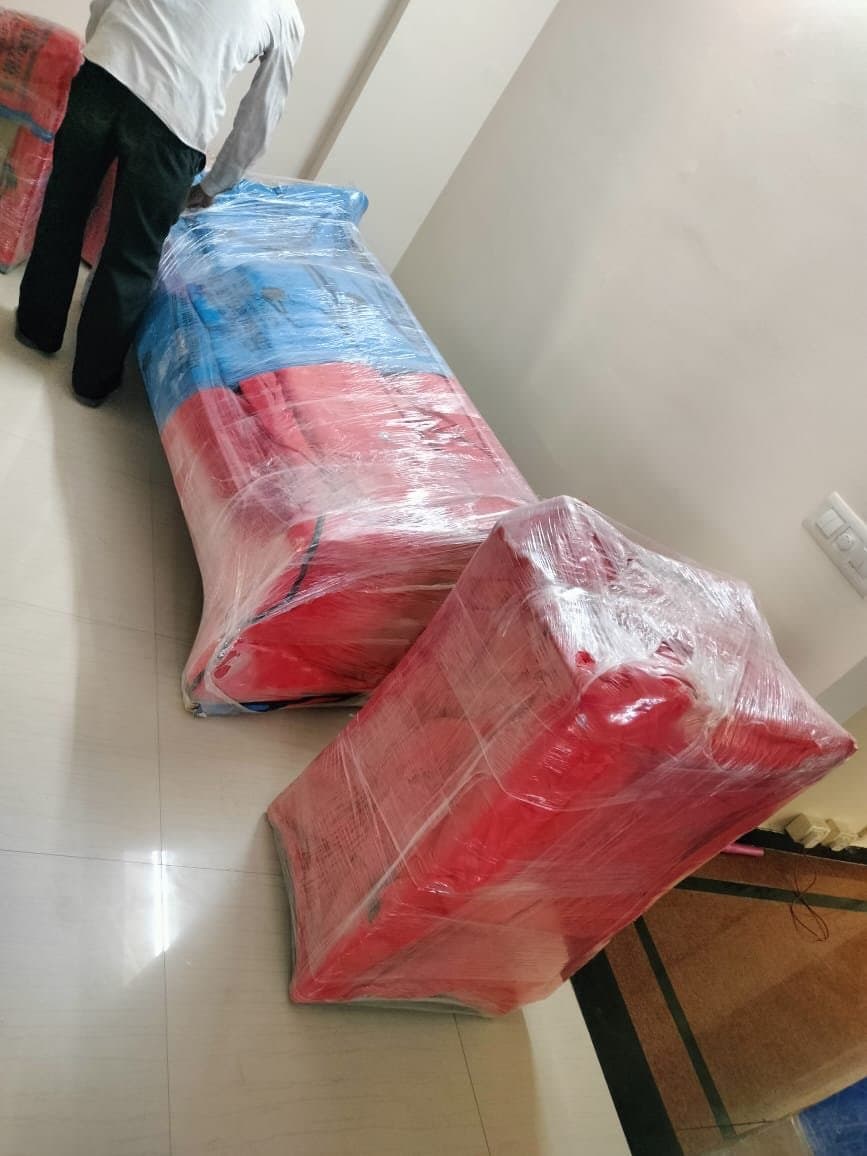 Bedding and household items wrapped into large red bundles