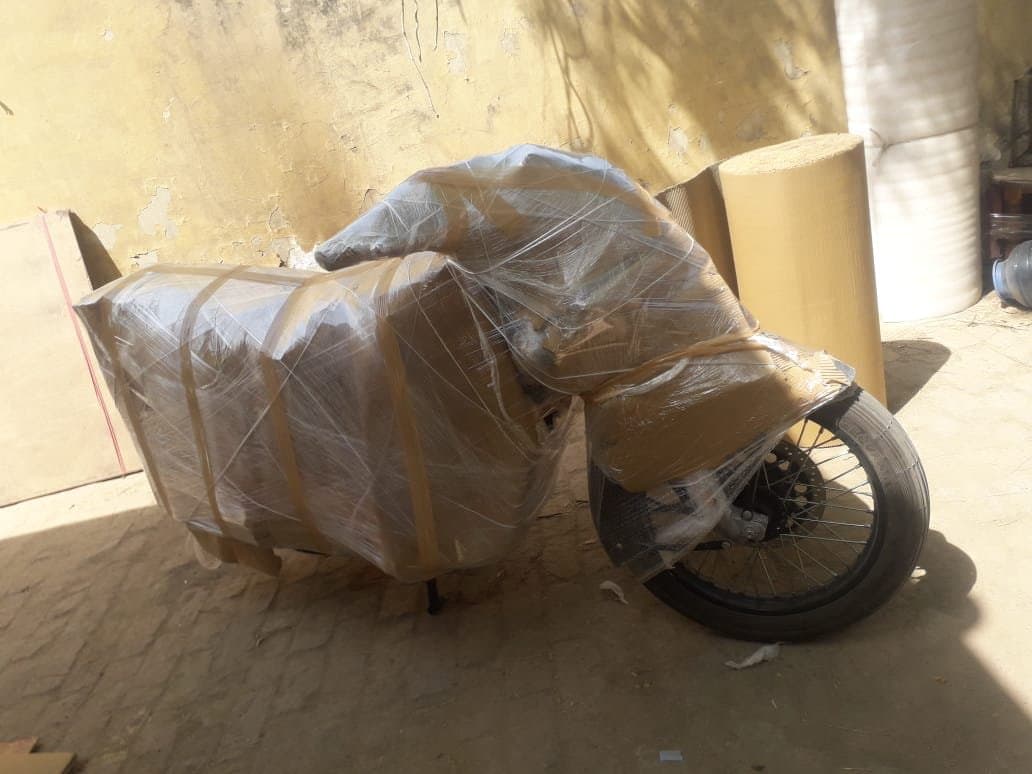 Motorcycle wrapped in plastic and cardboard for transport