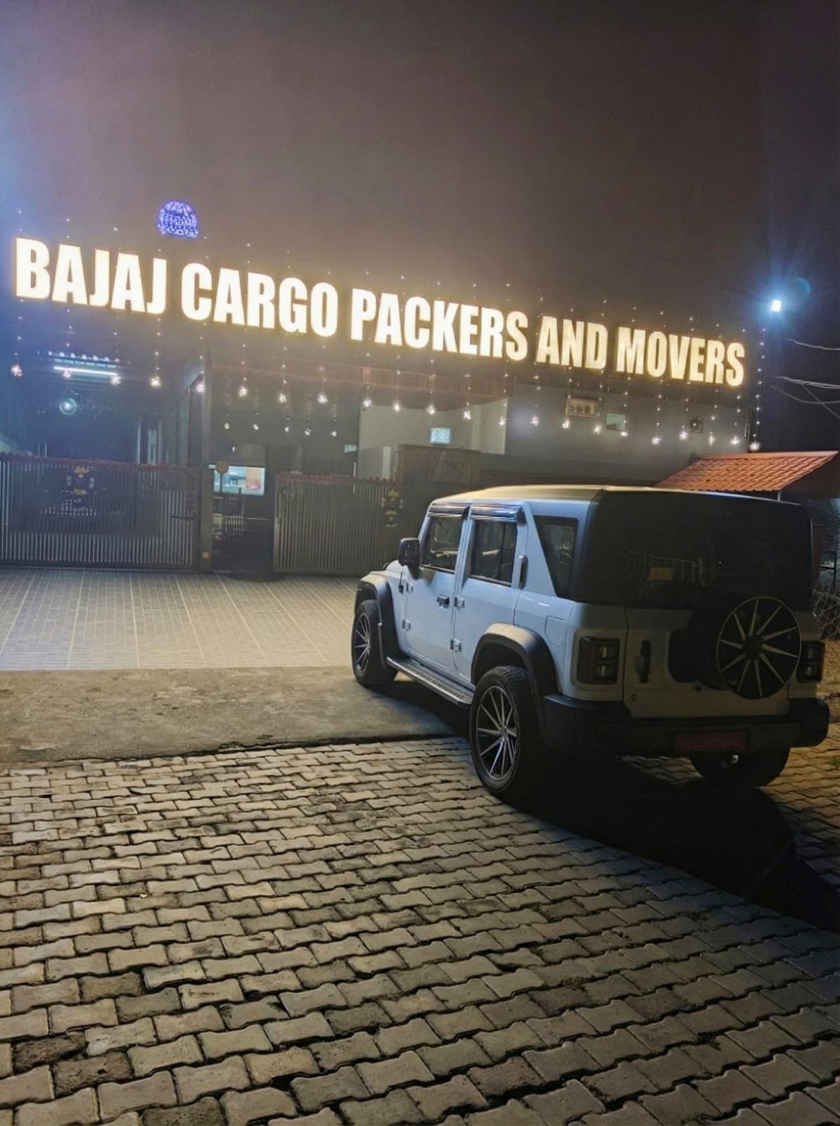 Bajaj Cargo Packers and Movers illuminated office signage at night