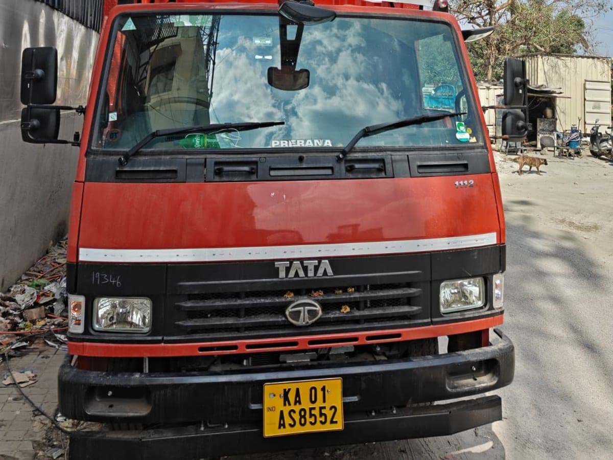 The cab and registration plate of the company's moving truck, parked on a residential street
