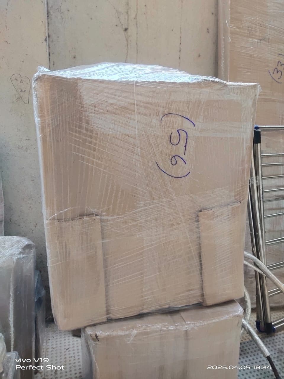 A large corrugated carton wrapped in stretch film and numbered for a household shift