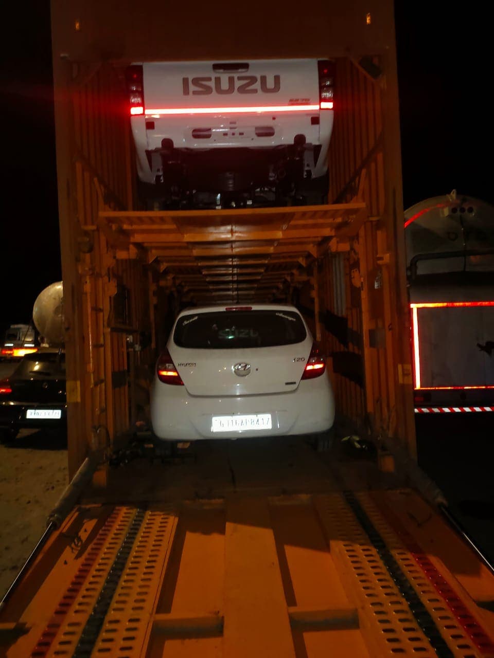Hatchback secured inside an enclosed car carrier at night