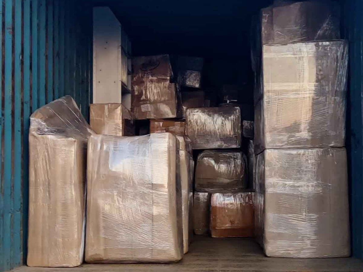 Wrapped furniture and cartons packed floor to ceiling inside a truck