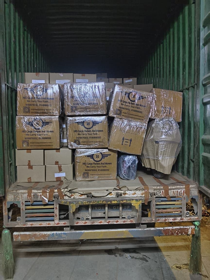 HKS Cargo branded cartons stacked and secured inside a container