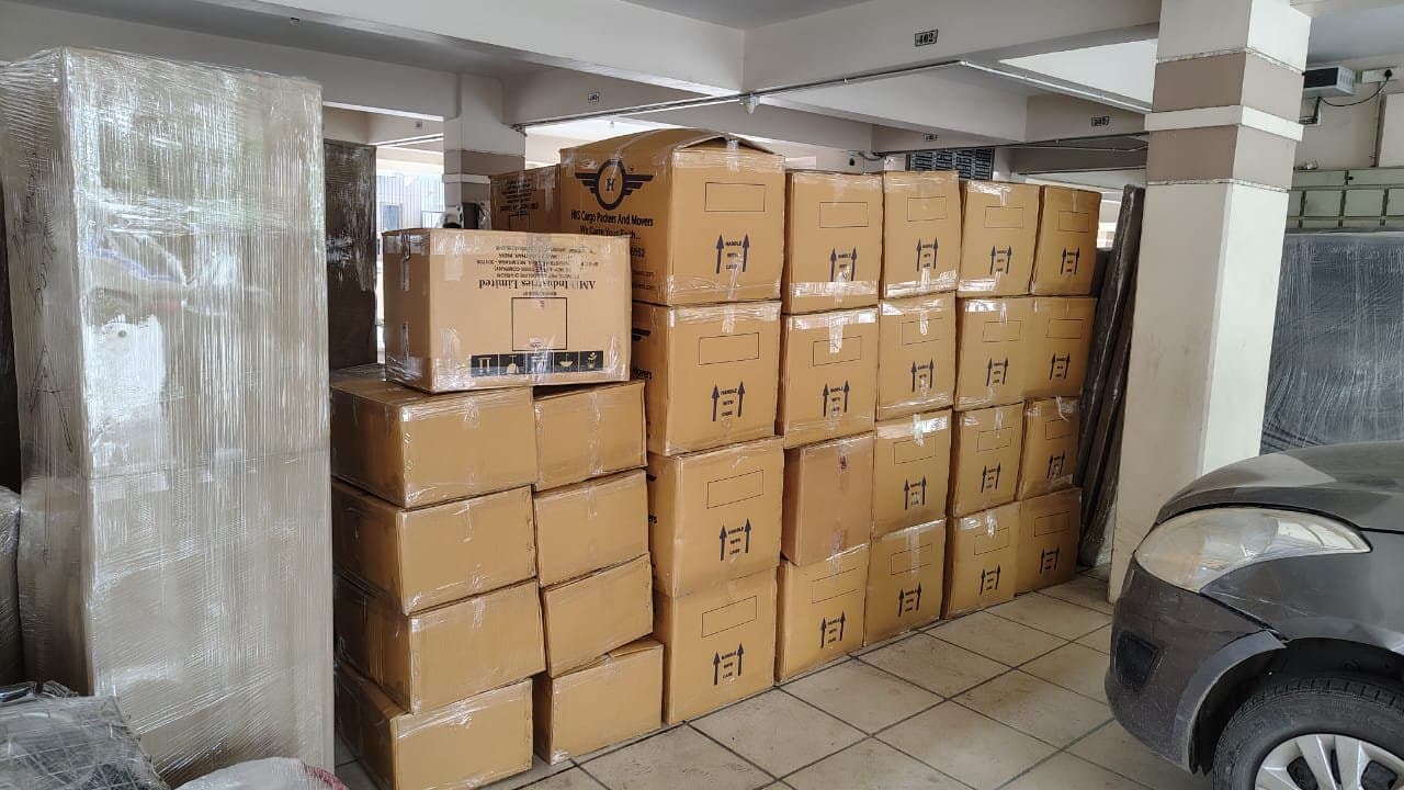 Rows of HKS Cargo cartons stacked in a storage bay