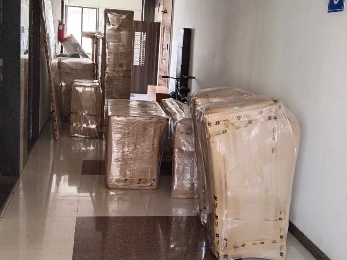 Wrapped furniture panels lined up along a hallway