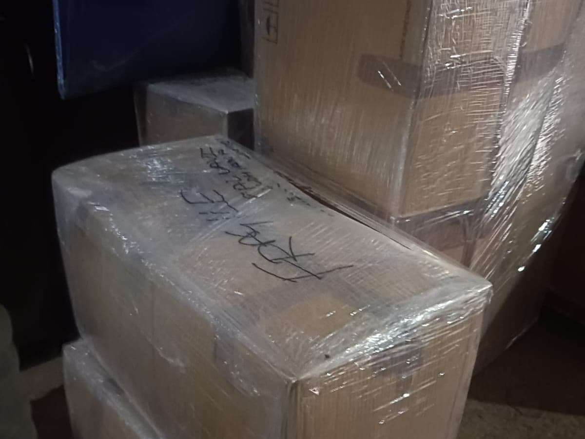 Wrapped cardboard cartons stacked and taped ahead of a move