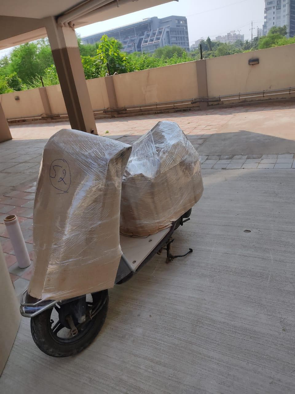 Electric scooter padded and wrapped for transport