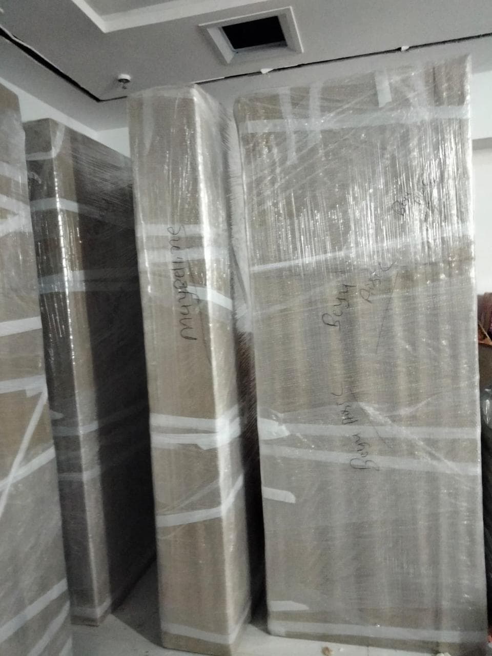 Mattresses wrapped in stretch film and labelled for transit