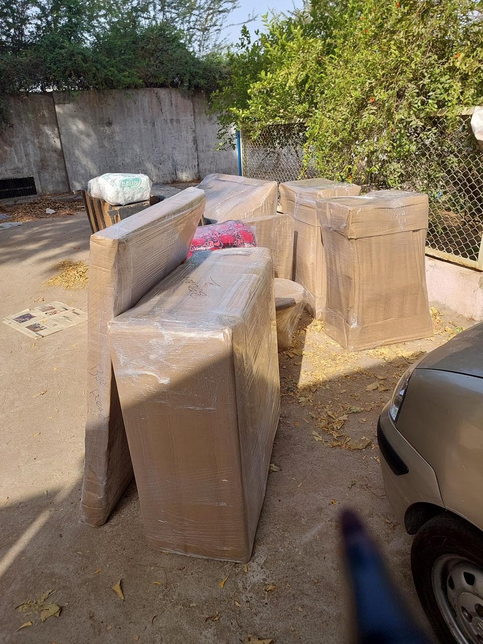 Full sofa set wrapped in cartons and film ready for the truck