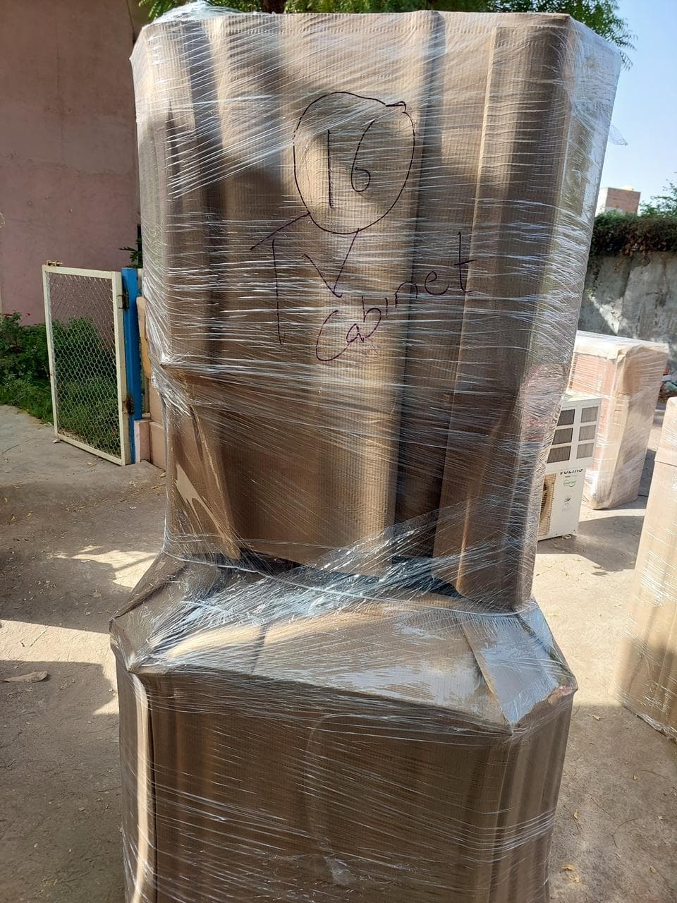 TV cabinet wrapped in corrugated board and stretch film