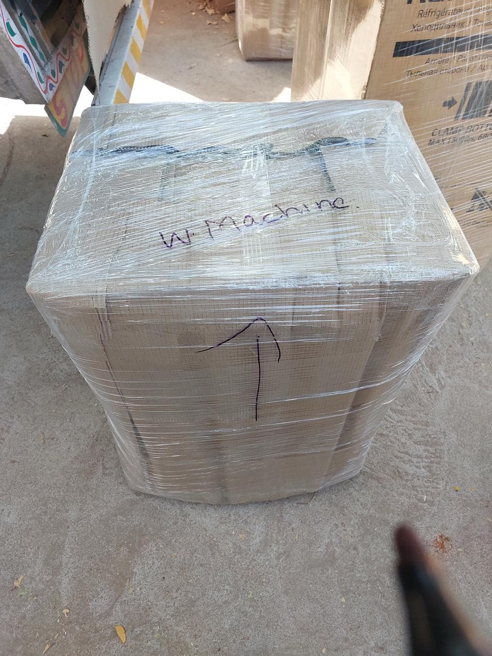 Washing machine boxed, wrapped and labelled for transport