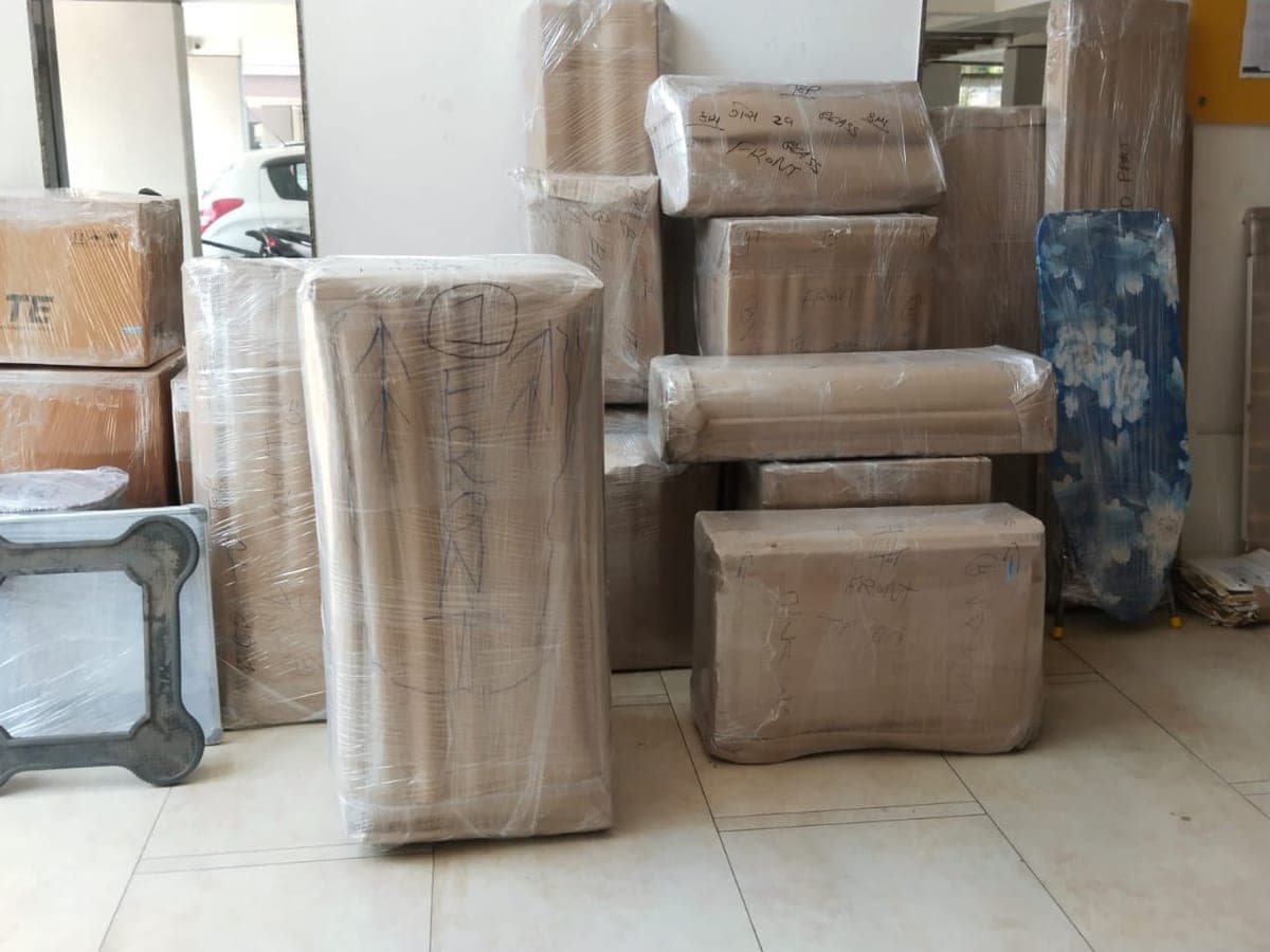 Wrapped wardrobe and stacked cartons ready for loading