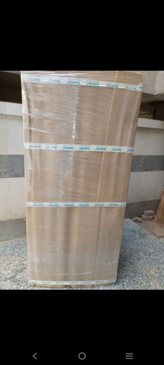 Tall almirah wrapped in corrugated board and stretch film