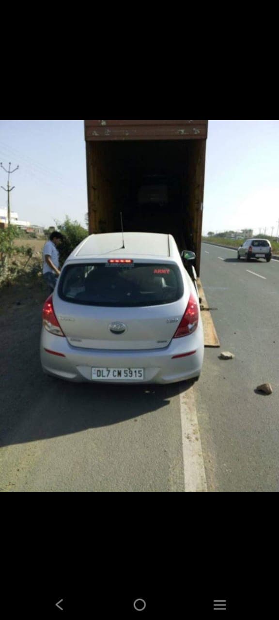 Car being loaded for transportation by Utkarsh Packers and Movers