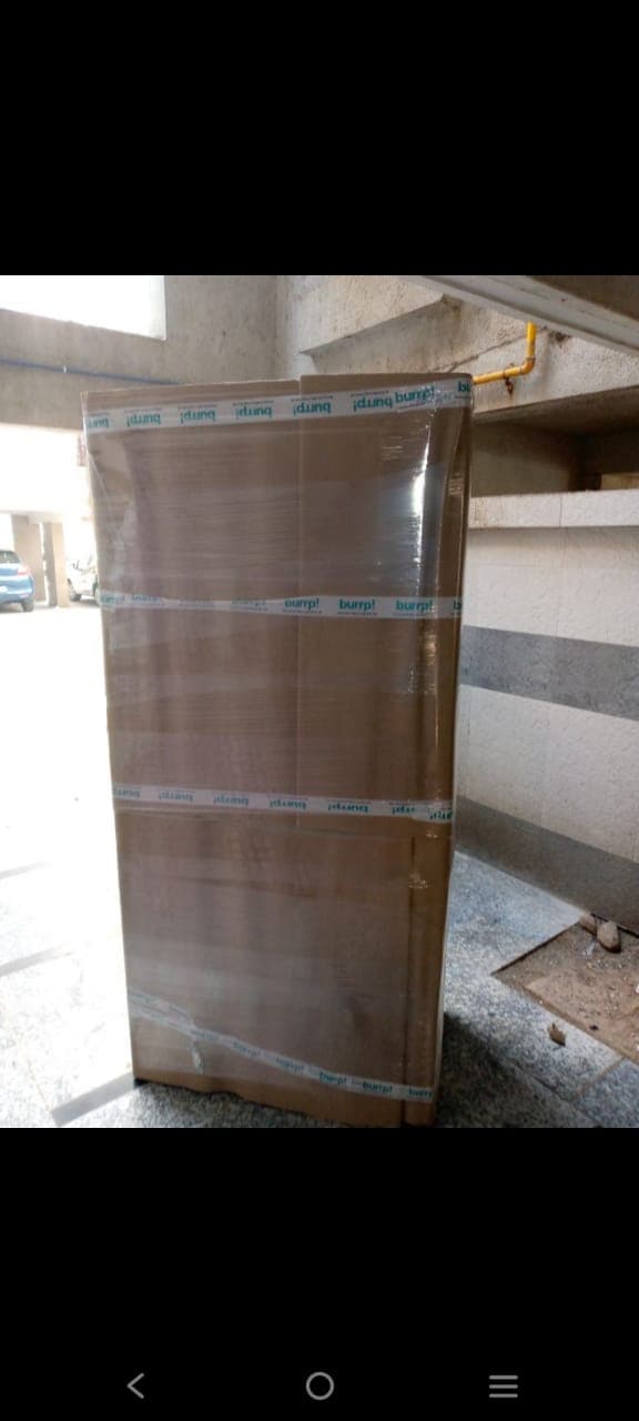 Tall appliance wrapped in corrugated sheets and stretch film