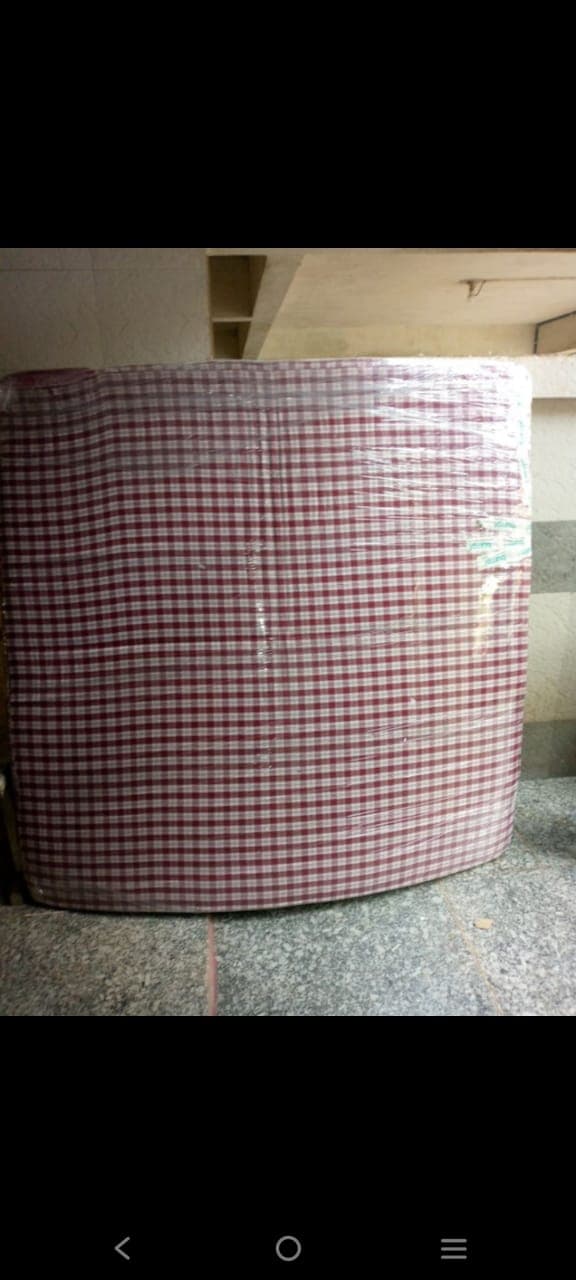 Mattress wrapped in stretch film ready to load