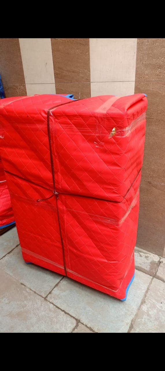 Furniture protected with red quilted moving covers