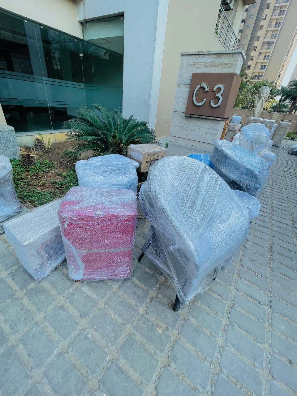 Chairs and household furniture wrapped outside an apartment building