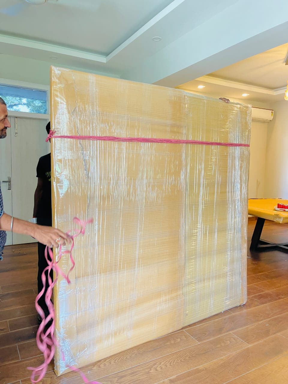 Large furniture panel wrapped in corrugated sheet and stretch film